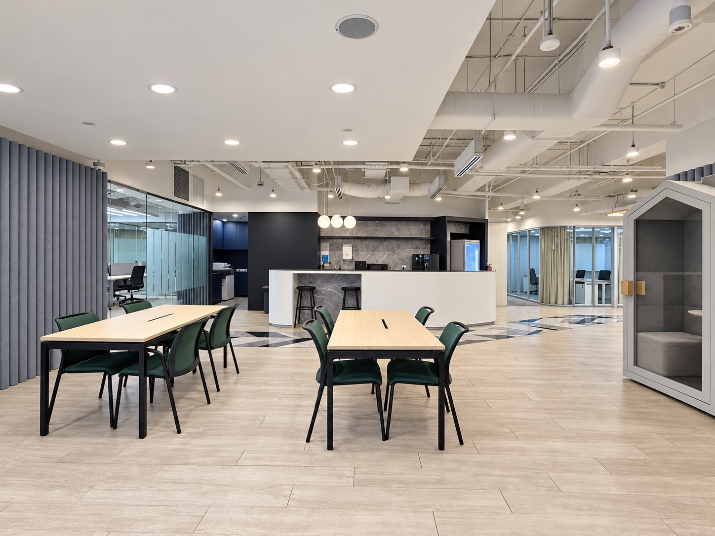 Shared seating area with tables and a pantry counter at HarbourFront Tower 2