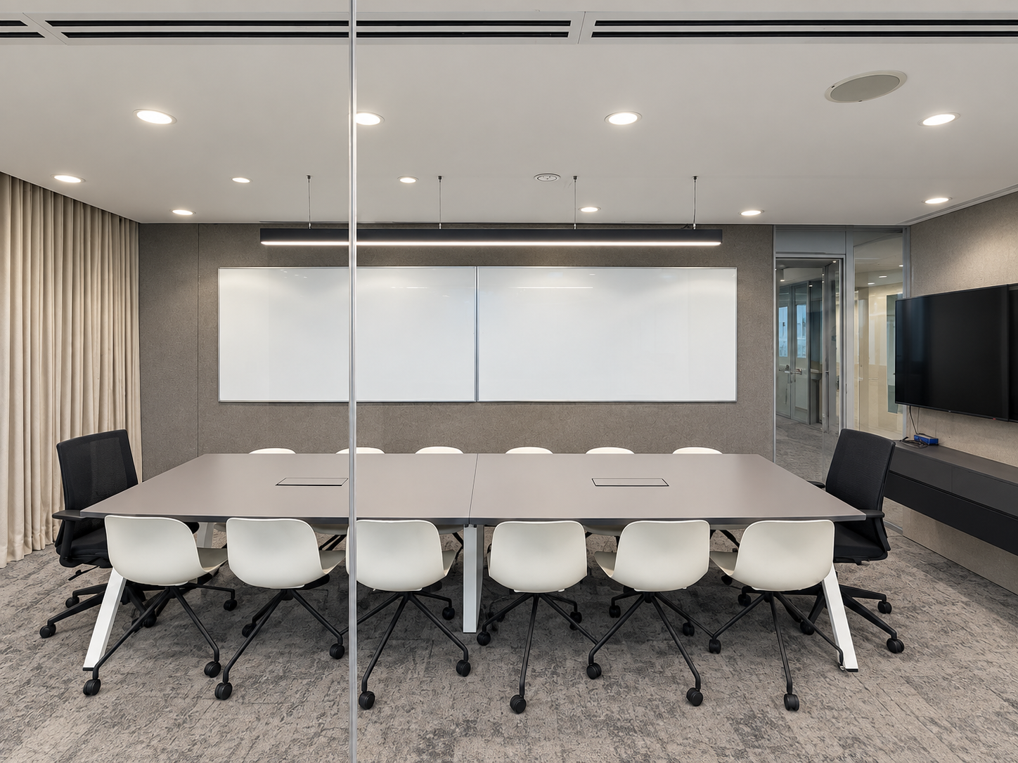 Glass-fronted meeting room with a long table and whiteboard at HarbourFront Tower 2